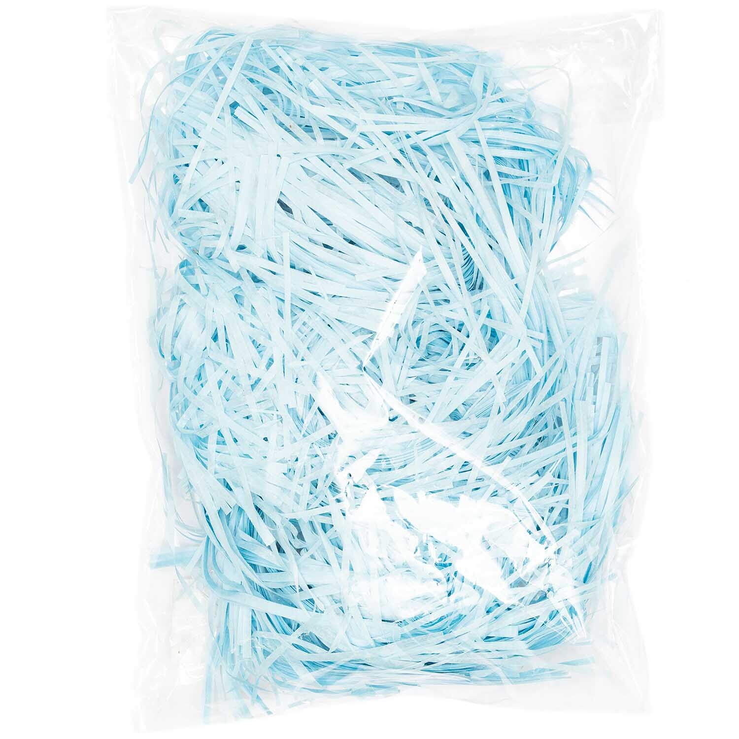 Ostergras 30g von Rico Design in Hellblau, verpackt in einer transparenten Plastiktüte. Ideal für Dekorationen.