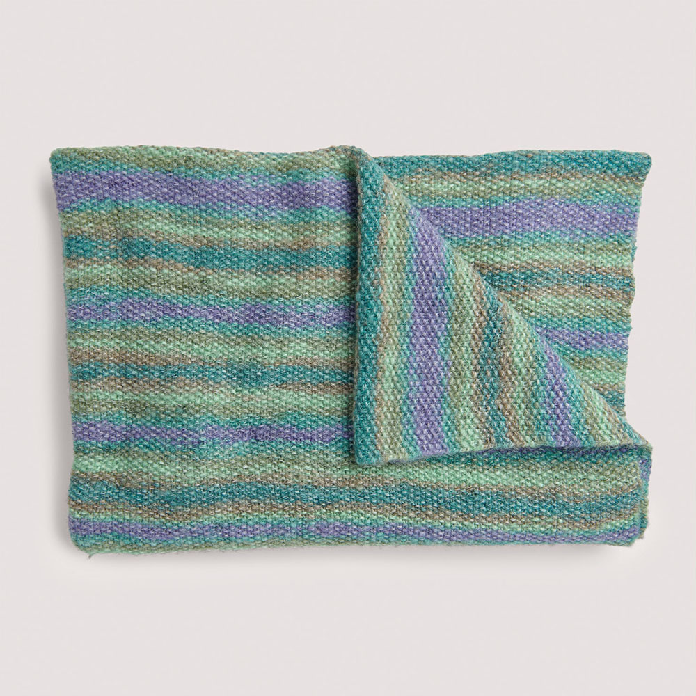 Blaue Decke auf grauem Hintergrund – zum Strickset