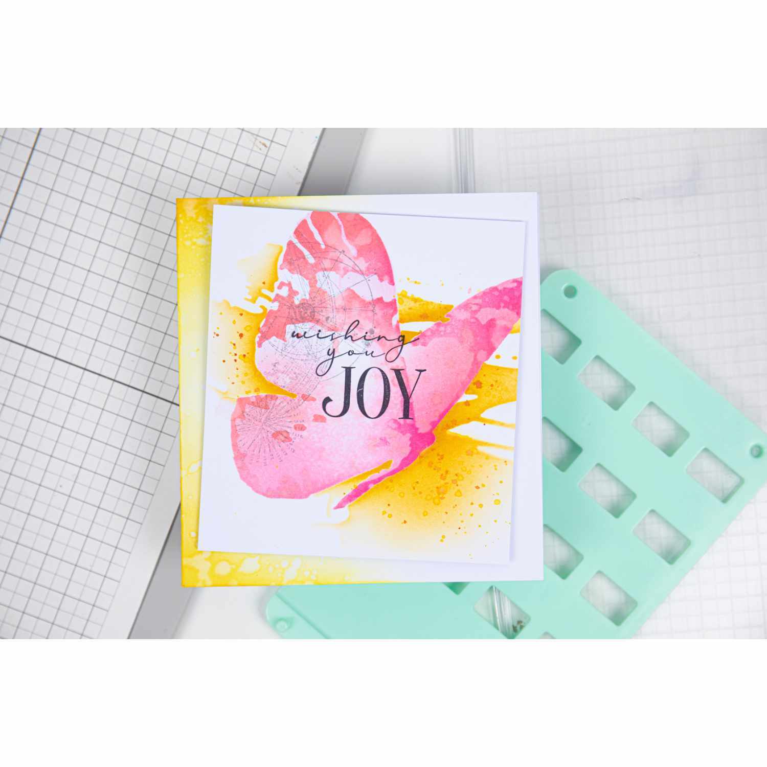 Layered Stencils Butterfly by Olivia Rose: Buntes Schmetterlingsdesign auf Karte mit "Wishing You Joy"-Text, ideal für kreative Projekte.