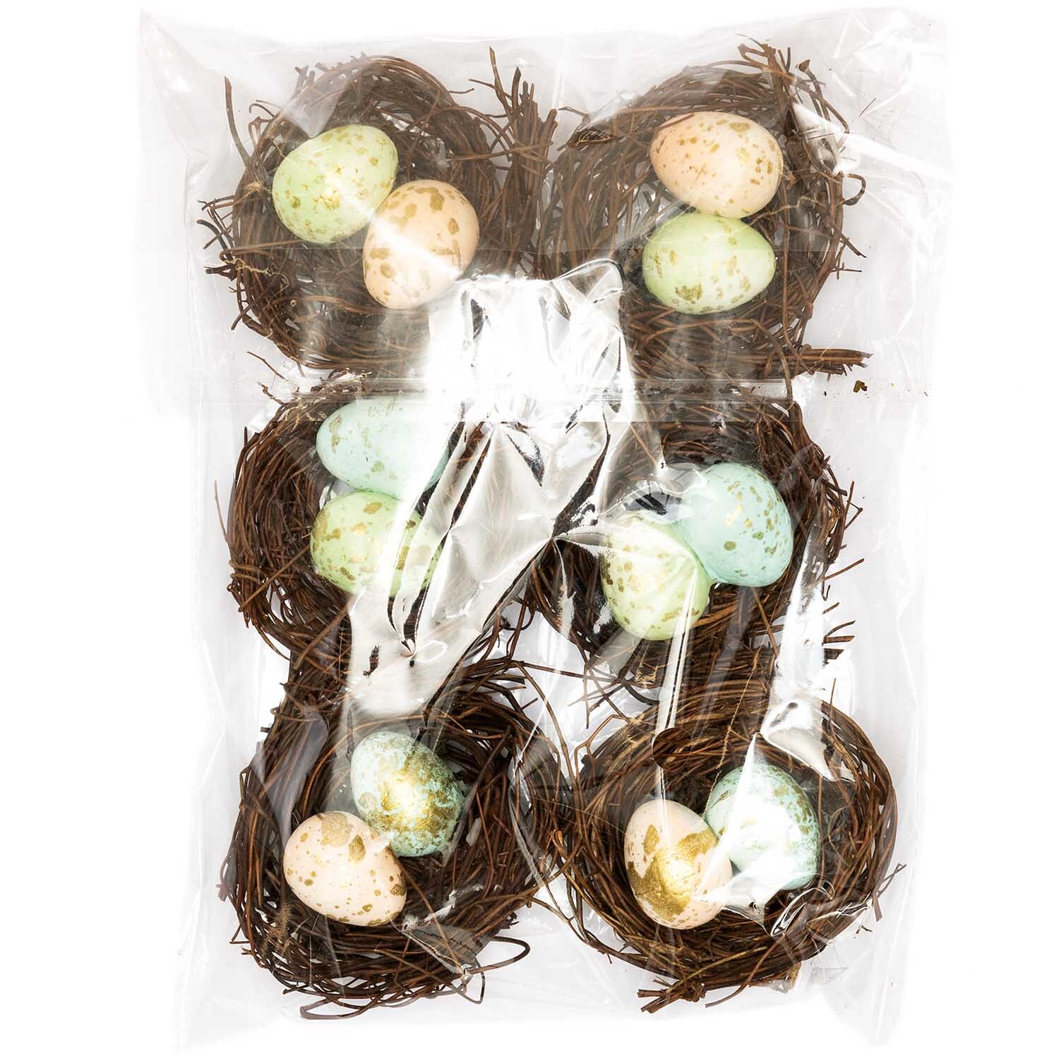 Osternest mit Eiern dunkel 7cm 6 Stück: Sechs dekorative Nester mit pastellfarbenen Eiern, ideal für Frühlingsdekorationen.