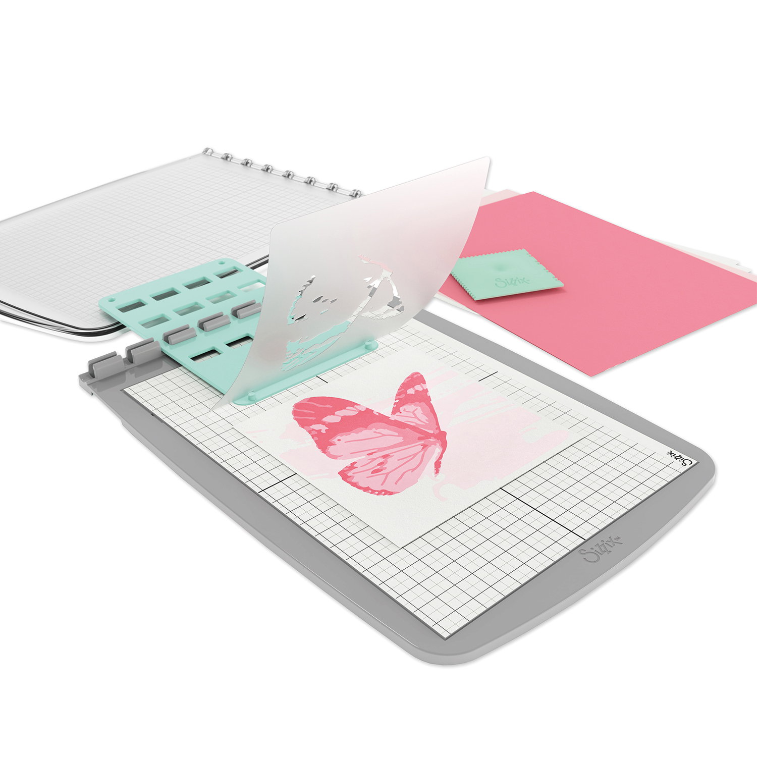 Stencil & Stamp Tool von Sizzix: Ein graues Werkzeug mit Schablone und Stempel auf einem Tisch. Ideal für kreative Bastelprojekte.