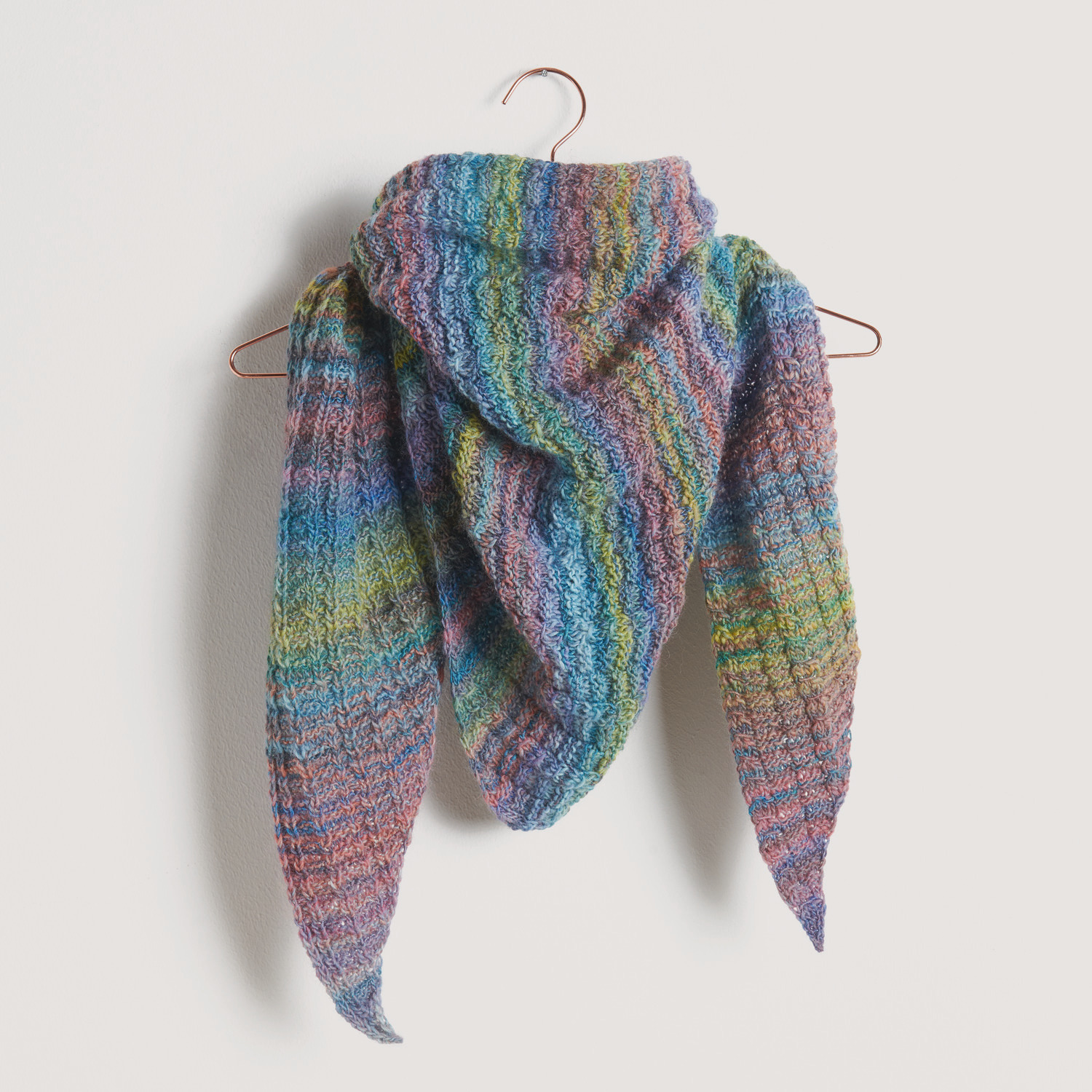 Buntes Dreieckstuch auf grauem Hintergrund – zum Strickset