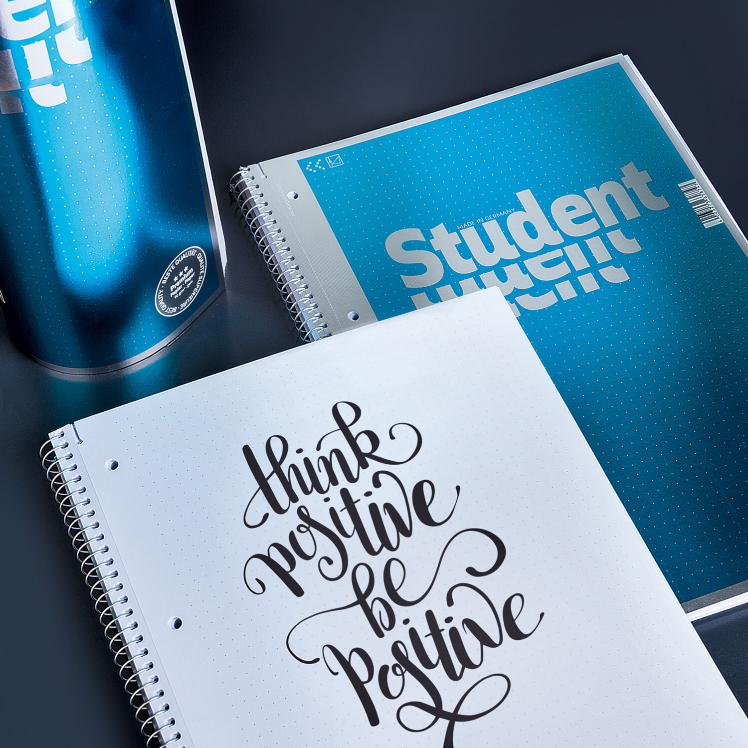 Collgeblock Premium Student A4 80 Blatt punktiert neben einer blauen Trinkflasche auf einem Tisch.