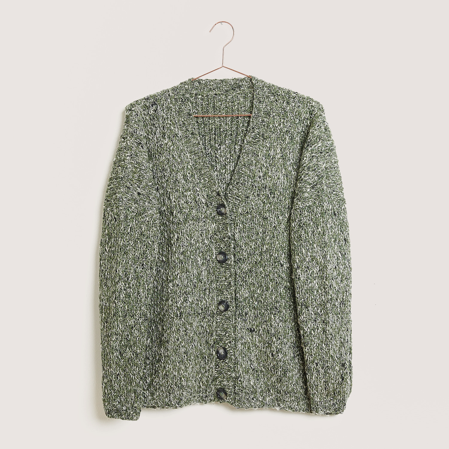 Rico Design Fun Alpaka Cotton Blend aran Strickjacke in Oliv mit Knopfleiste, hängend an einem Kleiderbügel vor neutralem Hintergrund.