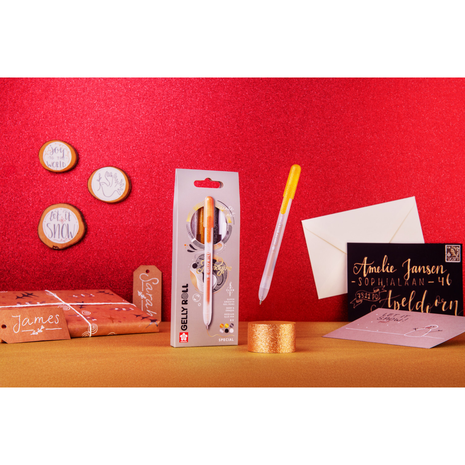 Gelly Roll Retractable Set Special von SAKURA, 6 Stück, auf rotem Hintergrund mit Briefumschlägen und Dekorationen.