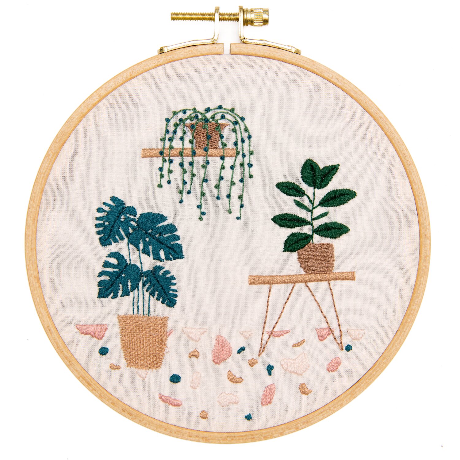 Stickpackung Slow Evenings Botanical zeigt bestickte Zimmerpflanzen im Holzstickrahmen von Rico Design auf hellem Stoff, ideal für moderne DIY-Dekoration