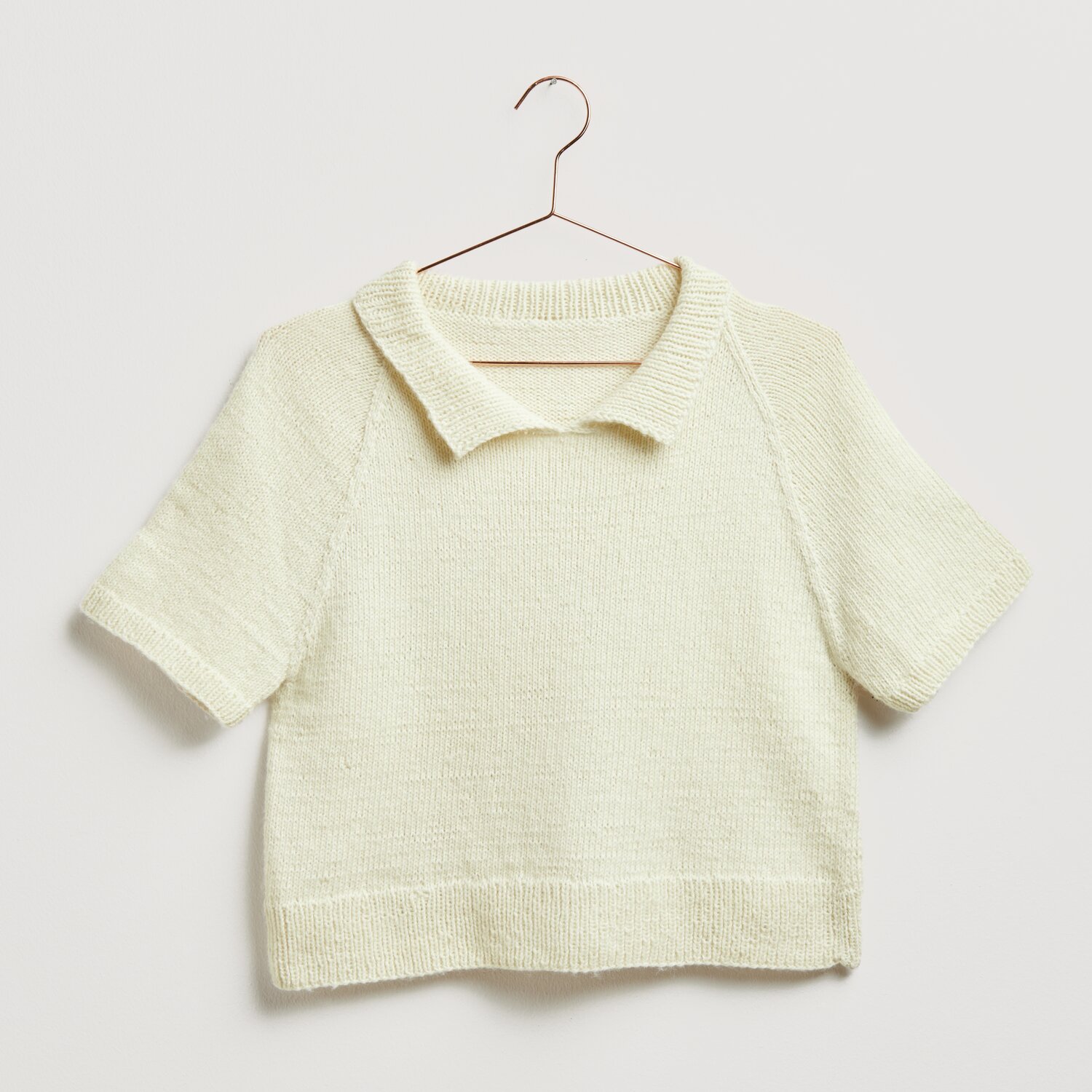 Strickset Shirt Modell 28 aus weichem Baumwollgarn, kurzärmelig mit Kragen, in Offwhite.