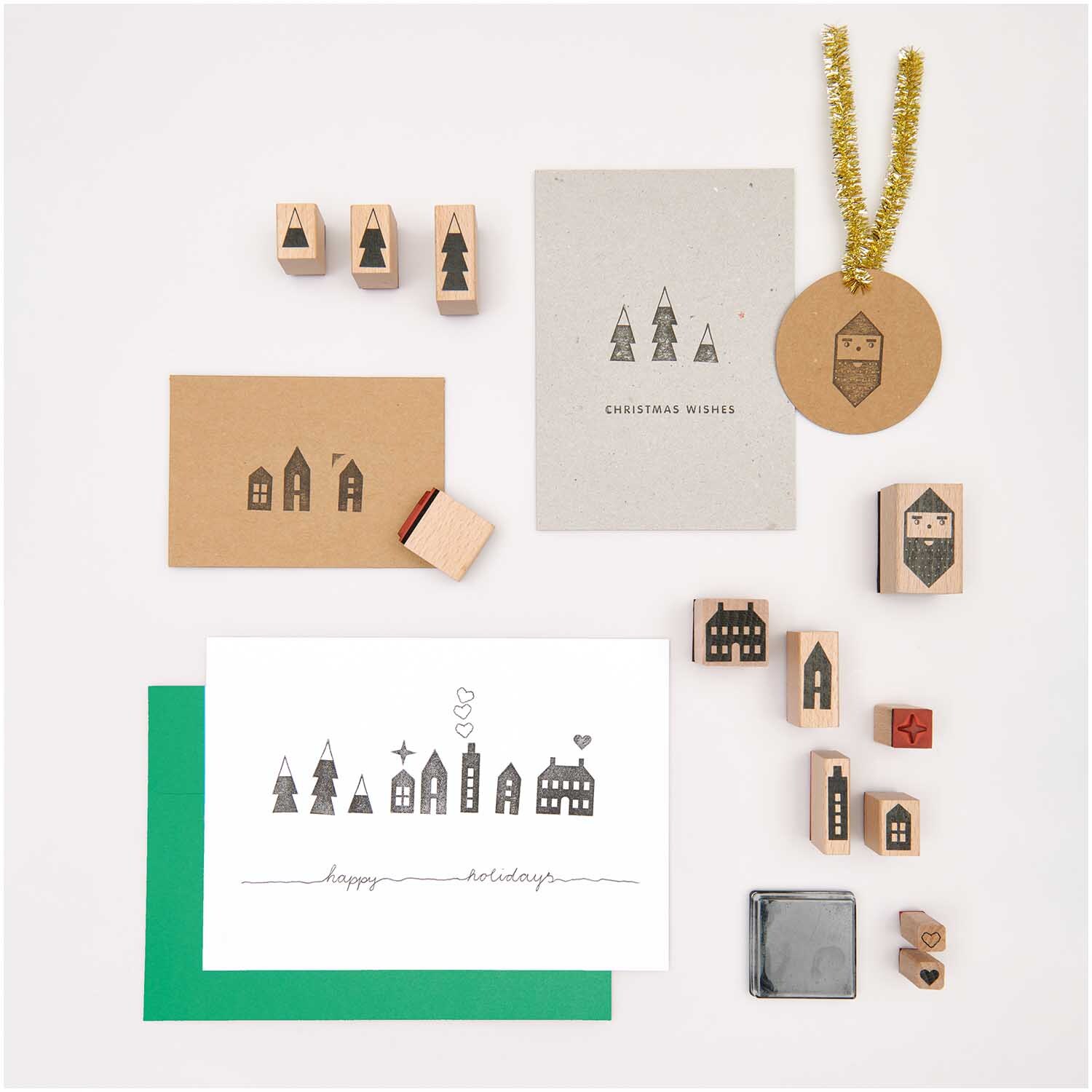 Paper Poetry Stempelset Häuser, 13-teilig, zeigt verschiedene Stempel mit Hausmotiven auf Karten.