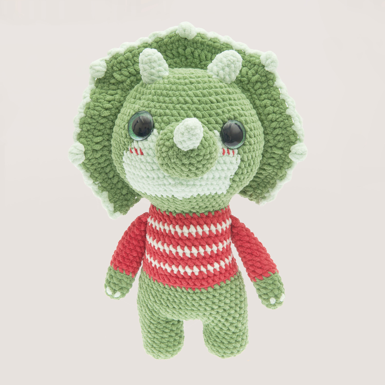 Häkelset Baby Dinosaur Modell 01: Grüner Dinosaurier mit rotem Streifenpullover aus Chenillove Big Cuties. Ideal für kreative Handarbeitsprojekte.