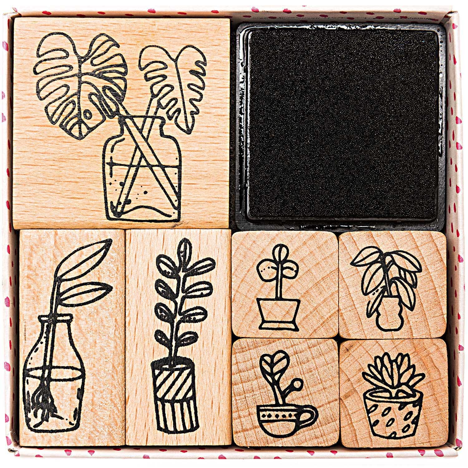 Paper Poetry Stempelset Hygge Plants, 8-teilig, zeigt Pflanzenmotive auf Holzstempeln mit Stempelkissen. Ideal für kreative Projekte.