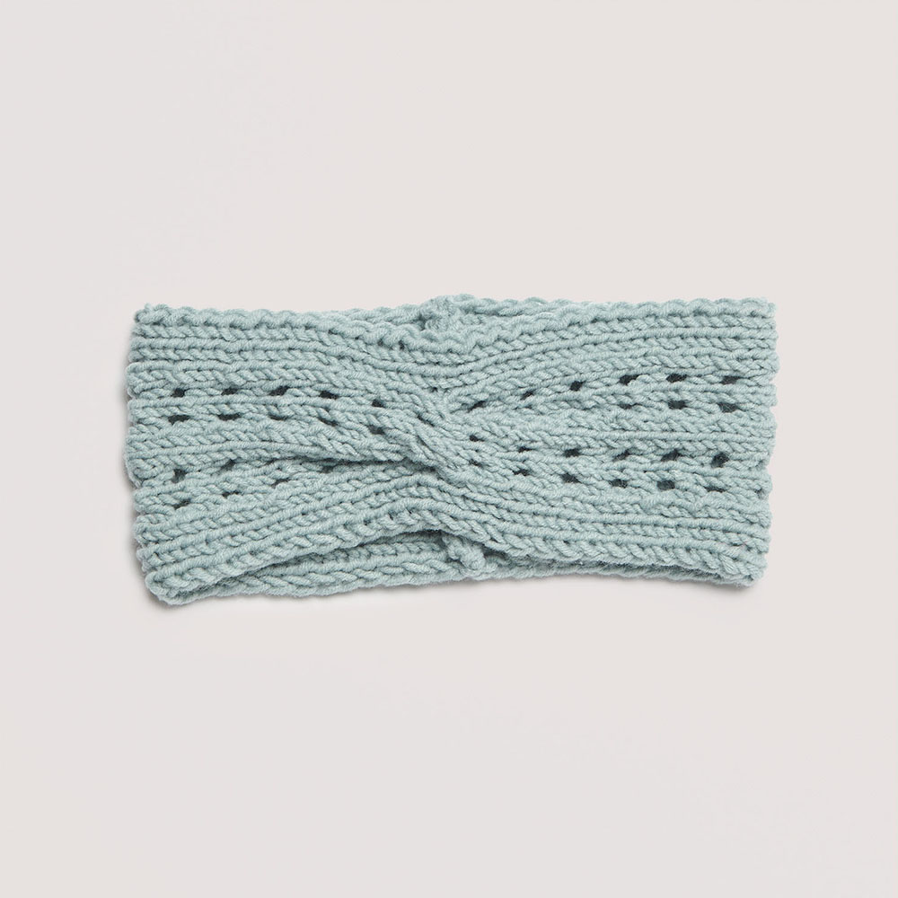 Stirnband mit Lochmuster auf grauem Hintergrund – zum Strickset
