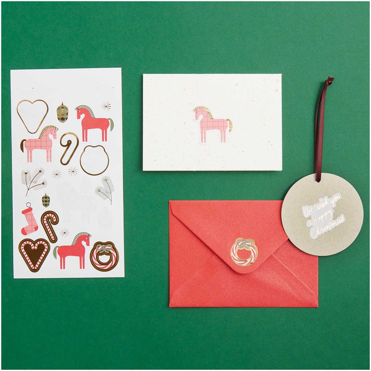 Paper Poetry Sticker Christmas Rocks! 4 Blatt: Weihnachtssticker, Karte und roter Umschlag auf grünem Hintergrund. Ideal für festliche Dekorationen.