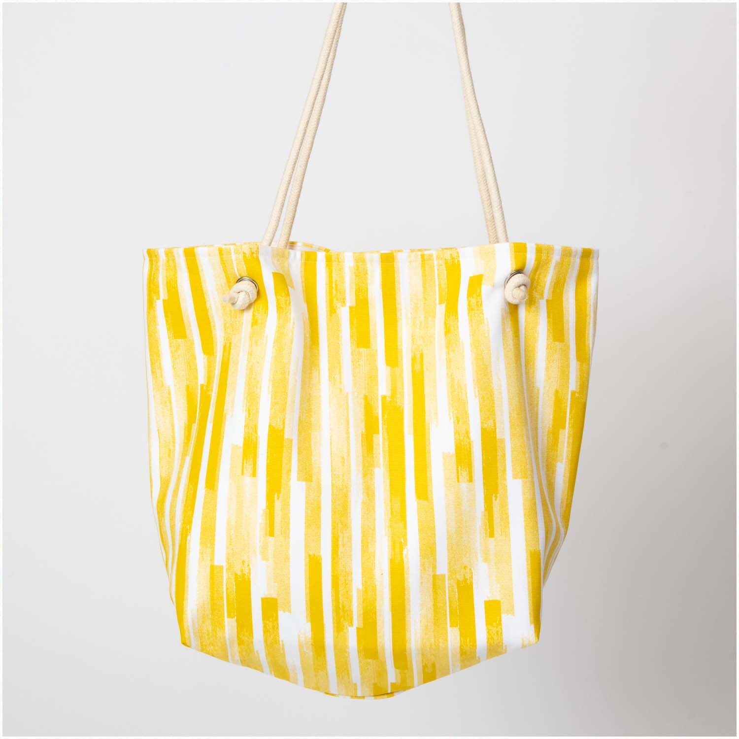 Druckstoff Canvas Aloha Streifen gelb-weiß 50x140cm von Rico Design. Stofftasche mit gelben und weißen Streifen, ideal für sommerliche Projekte.