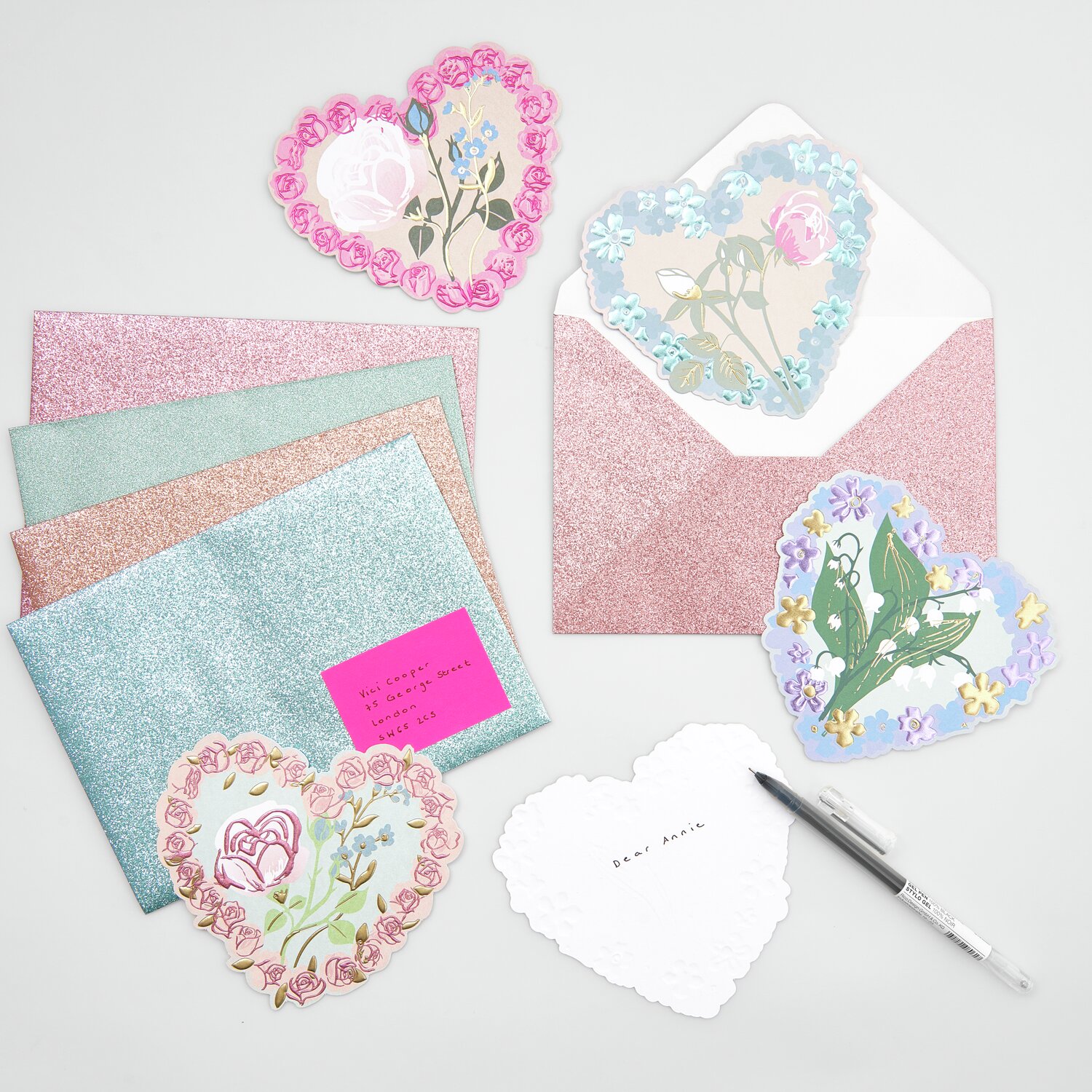 Paper Poetry Kartenset La Vie en Rose Herzen, 16-teilig, mit glitzernden Umschlägen und floralen Herzmotiven in Rosa und Blau.