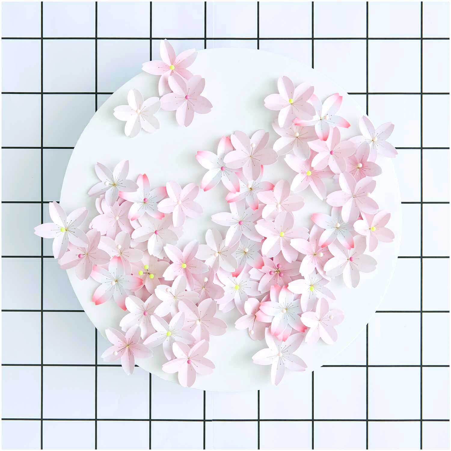 Paper Poetry Mini-Papierblüten Luxury Sakura, zartrosa Blüten auf weißem Hintergrund, ideal für kreative Dekorationen.