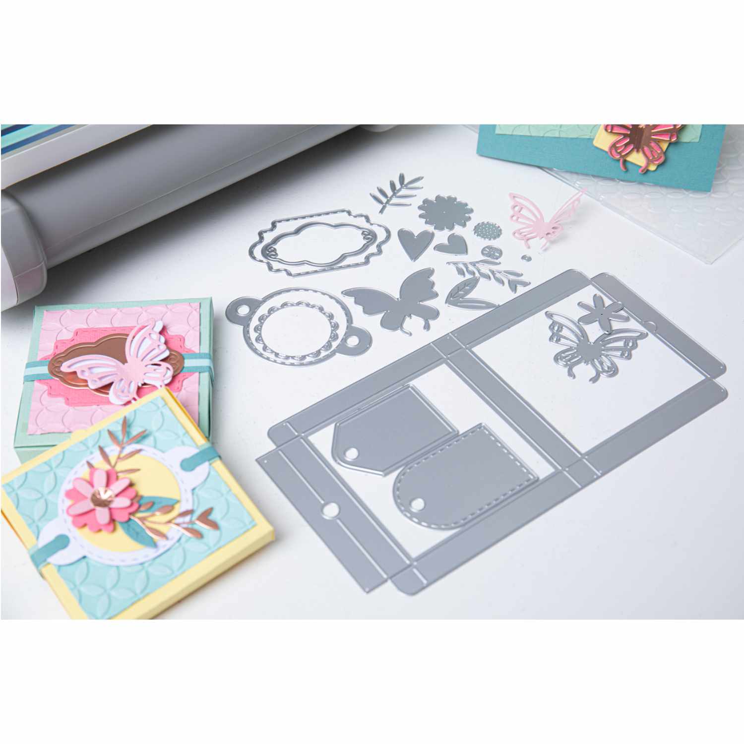 Big Shot Plus Starter Set mit Stanzformen und Karten in Pastelltönen, ideal für kreative Bastelprojekte.