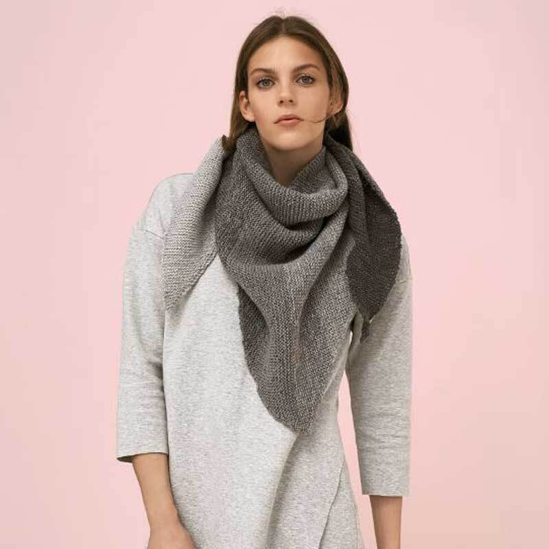 Creative Wool dégradé: Frau trägt einen grauen Schal von Rico Design vor rosa Hintergrund.