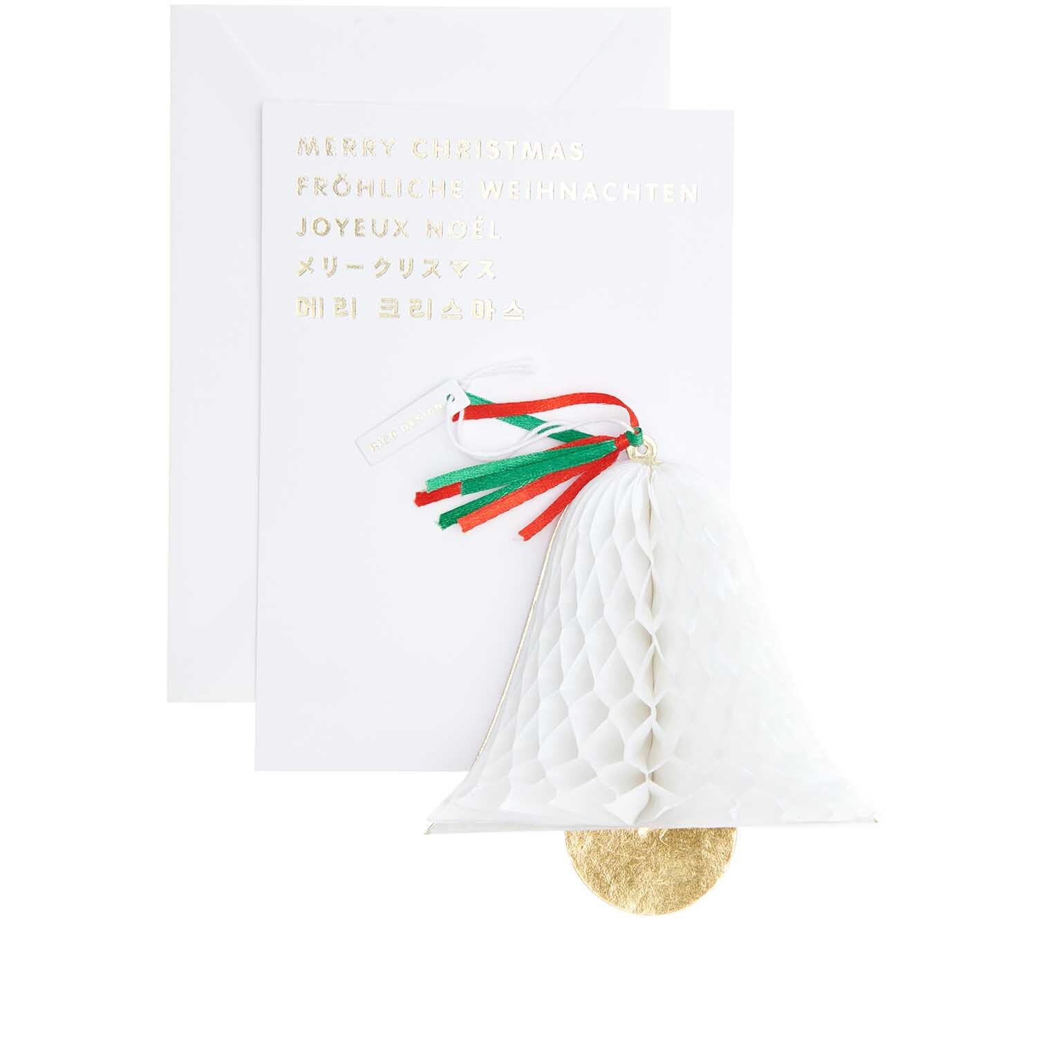 Paper Poetry Kartenset mit Pop-Up Anhänger Glocke B6 zeigt eine weiße Glocke mit roten und grünen Bändern vor einer Weihnachtskarte.