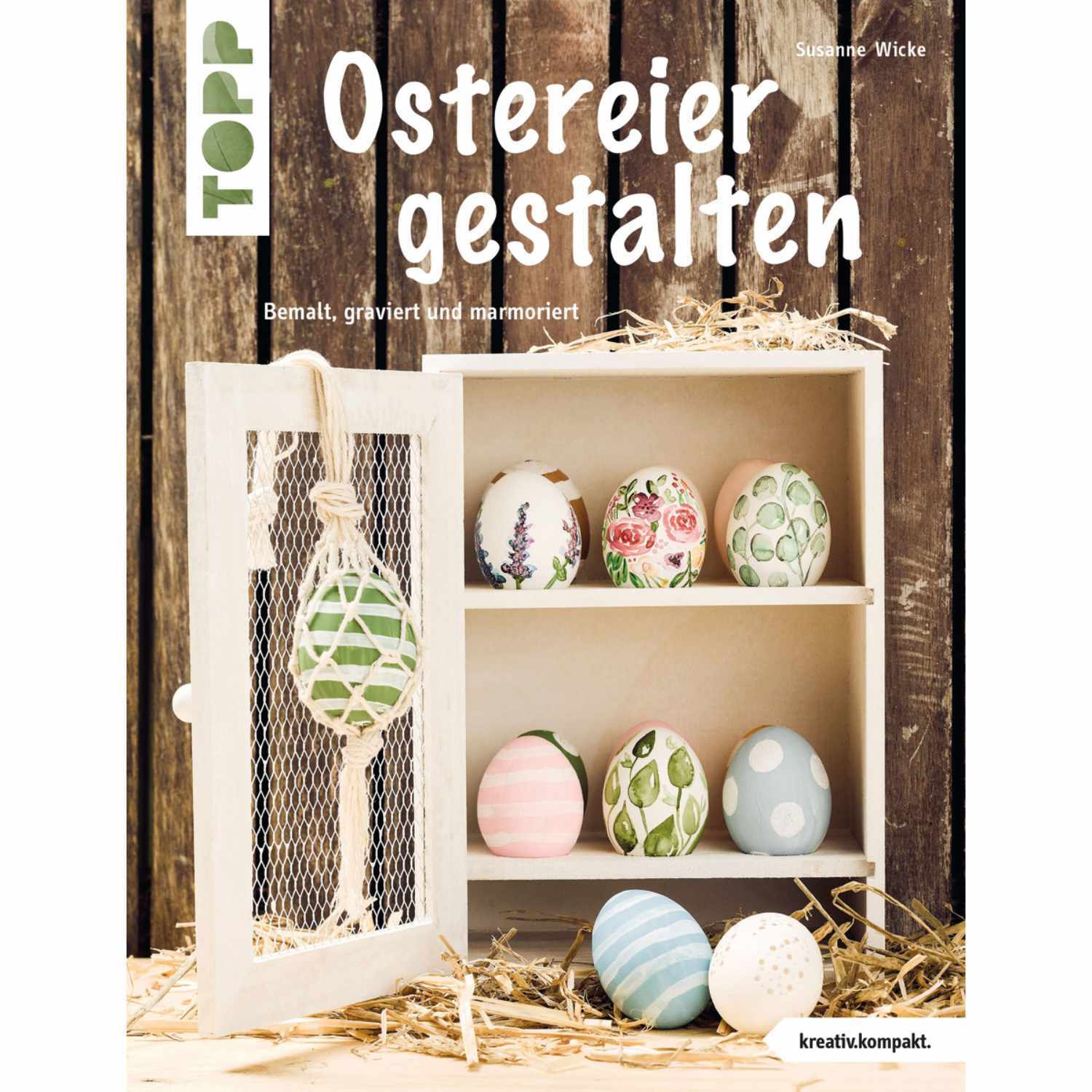 Ostereier gestalten: Ein Buch von TOPP zeigt dekorierte Ostereier in einem weißen Regal.