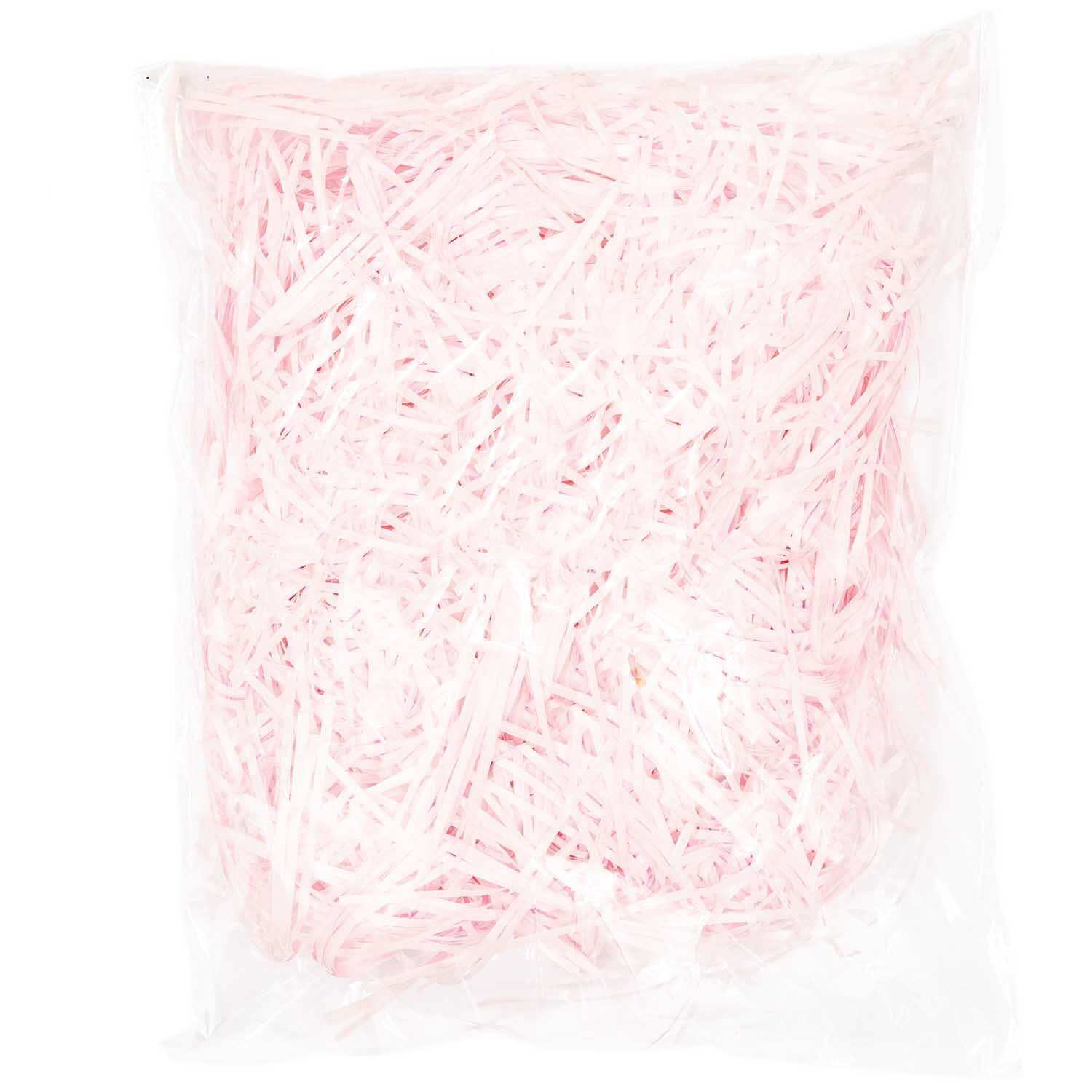 Ostergras 30g von Rico Design in Rosa, verpackt in einer transparenten Tüte, ideal für Dekorationen.