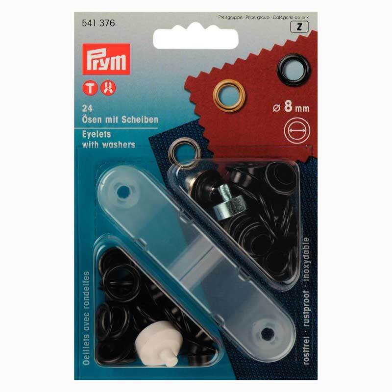 Ösen mit Scheiben brüniert 8mm 24 Stück von Prym, verpackt in einer blauen Schachtel mit schwarzem Inhalt.