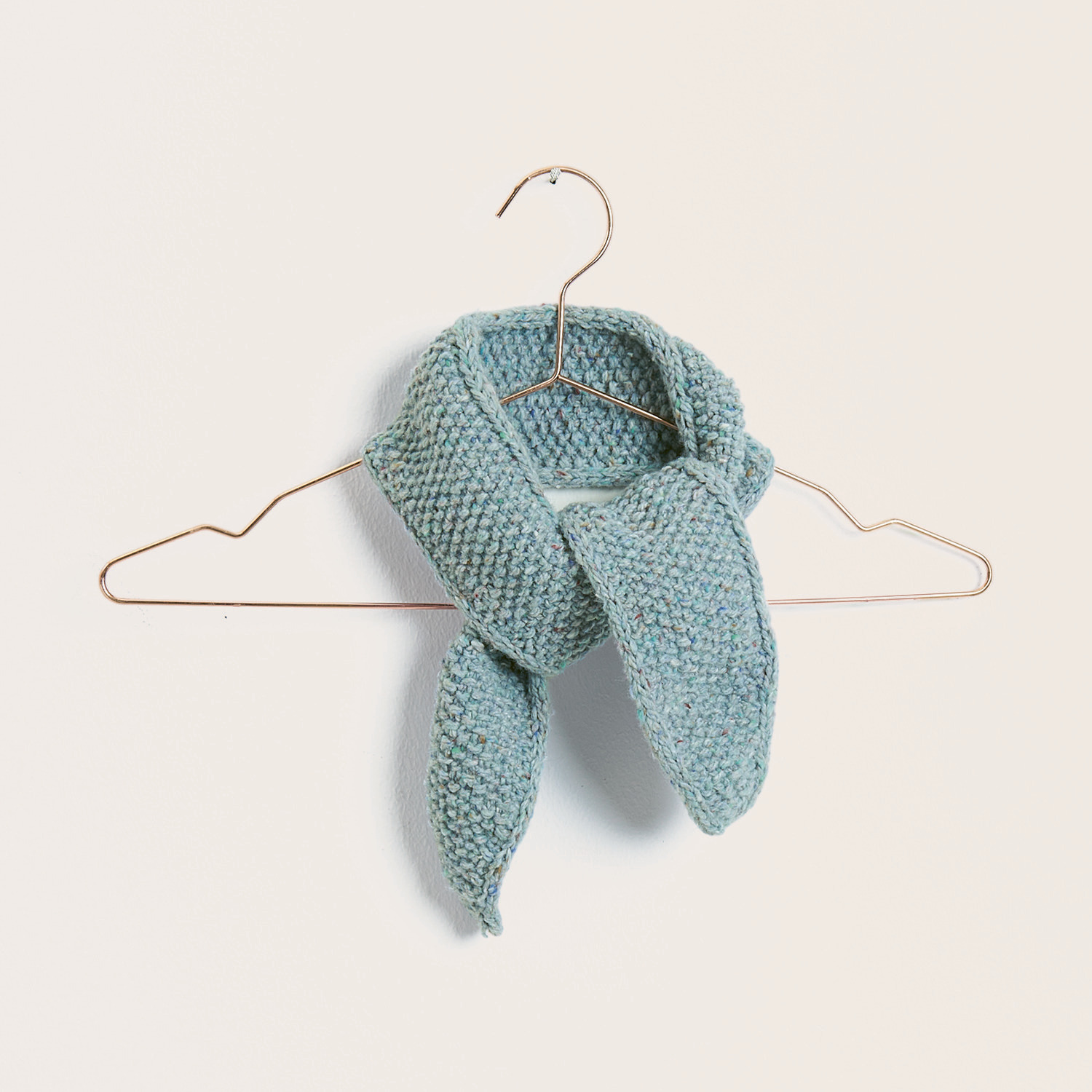 Strickset Tuch Modell 05 aus Trachtenbuch I mog di, hellblau, auf einem Kleiderbügel präsentiert.