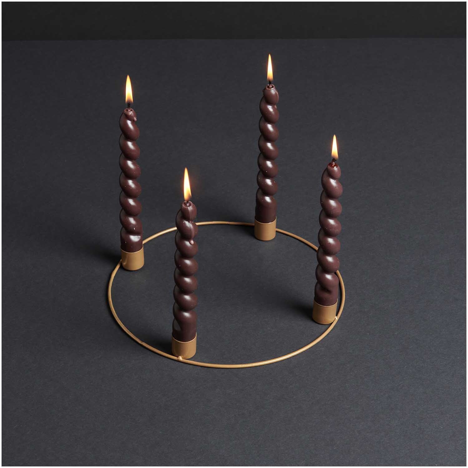 Metallring Adventskranz Ø 25cm mit vier gedrehten, brennenden Kerzen auf schwarzem Hintergrund. Goldener, matter Ring von Rico Design.