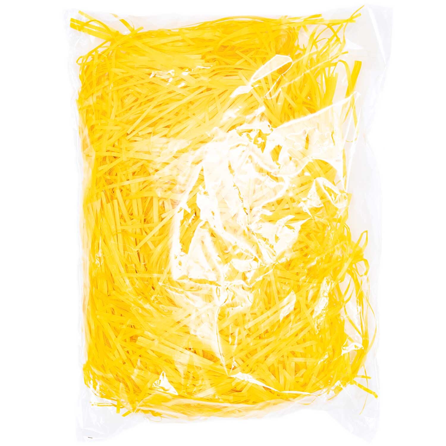 Ostergras 30g von Rico Design in Gelb, verpackt in einer transparenten Plastiktüte. Ideal für Dekorationen.