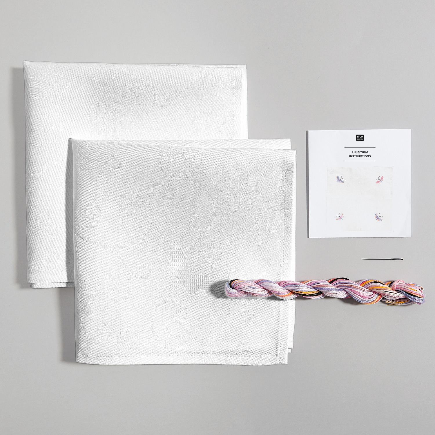 Stickpackung Servietten mit Schmetterlingen, 42x42cm, 2 Stück. Enthält weiße Servietten, Stickgarn und Anleitung von Rico Design.