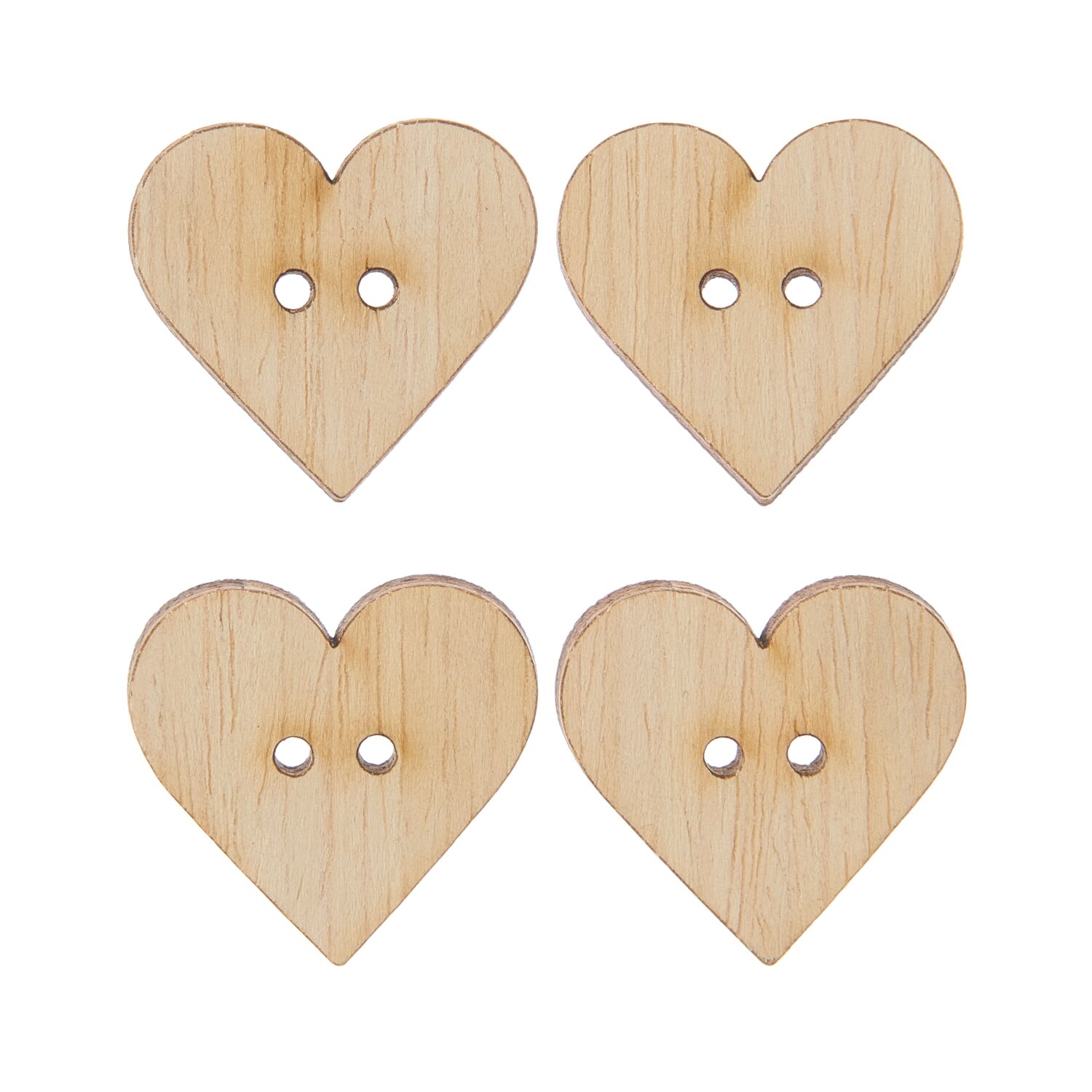 Vier Knöpfe in Herzform und aus naturbelassenem Holz.