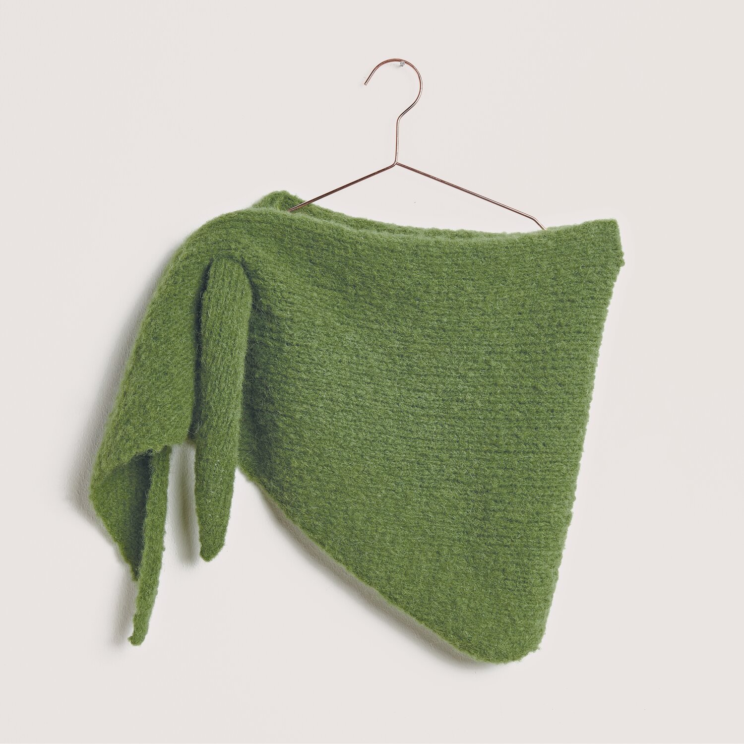 Strickset Dreieckstuch Modell 12 aus Made by Me No. 21, olivgrün, aus Baby Alpaca, hängt an einem Kleiderbügel.