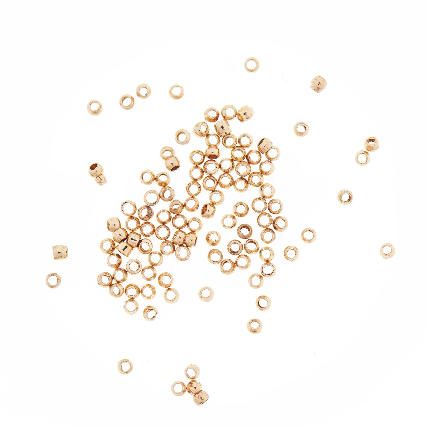 QuetschPerle gold 1,5mm 100 Stück, ideal für Schmuckdesign. Kleine, goldene Perlen von Rico Design auf weißem Hintergrund.