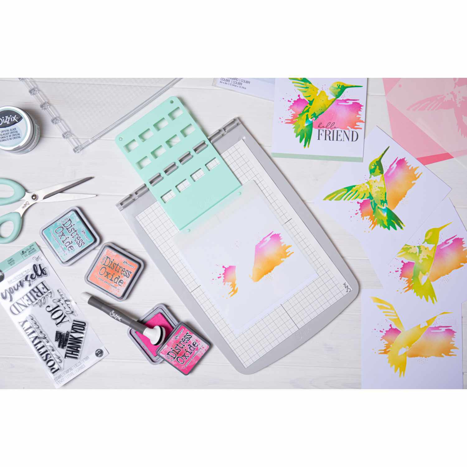 Stencil & Stamp Tool von Sizzix auf einem Tisch mit bunten Stempeln und Schablonen für kreative Projekte.