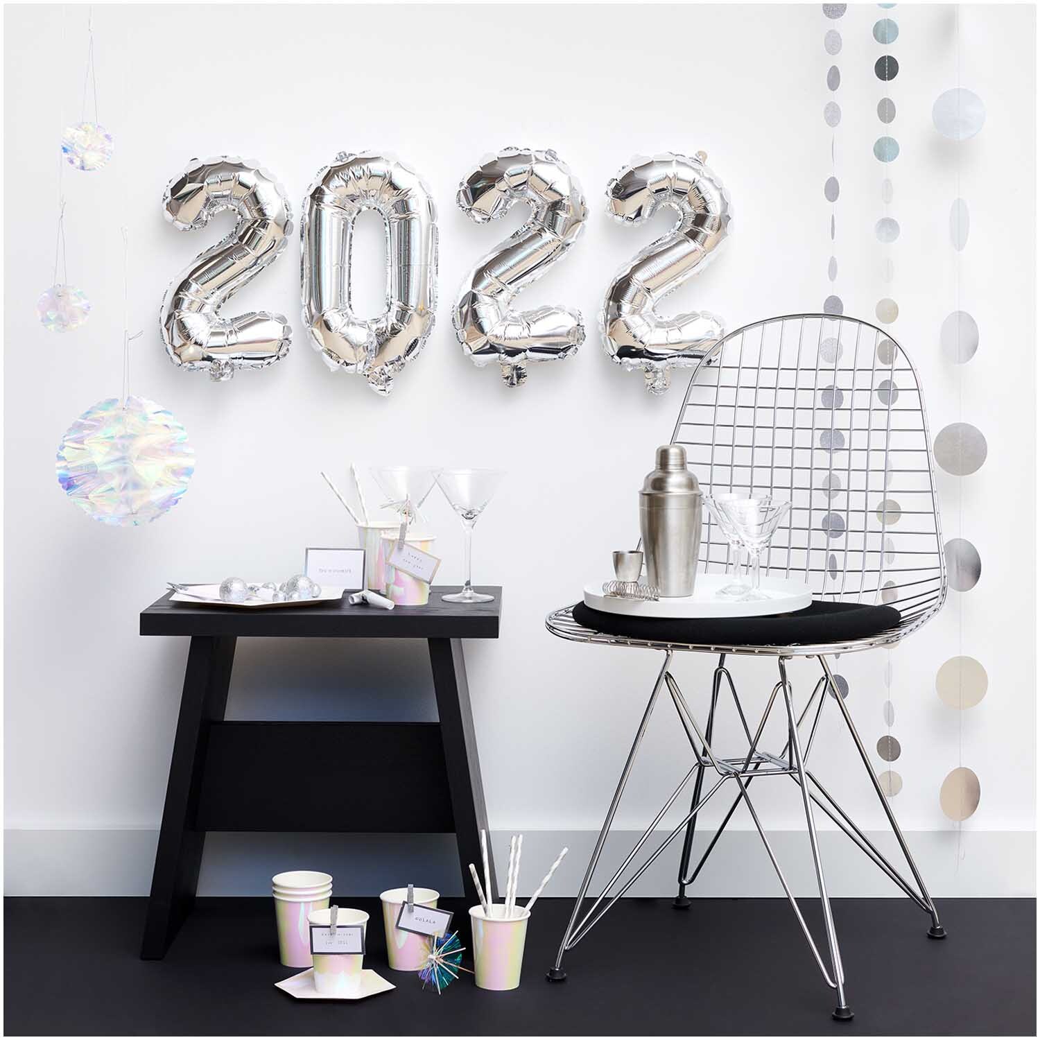 Genähte Girlande Kreise 8cm Glitter-silber 1,7m von Rico Design dekoriert einen modernen Raum mit silbernen Akzenten und Ballons.