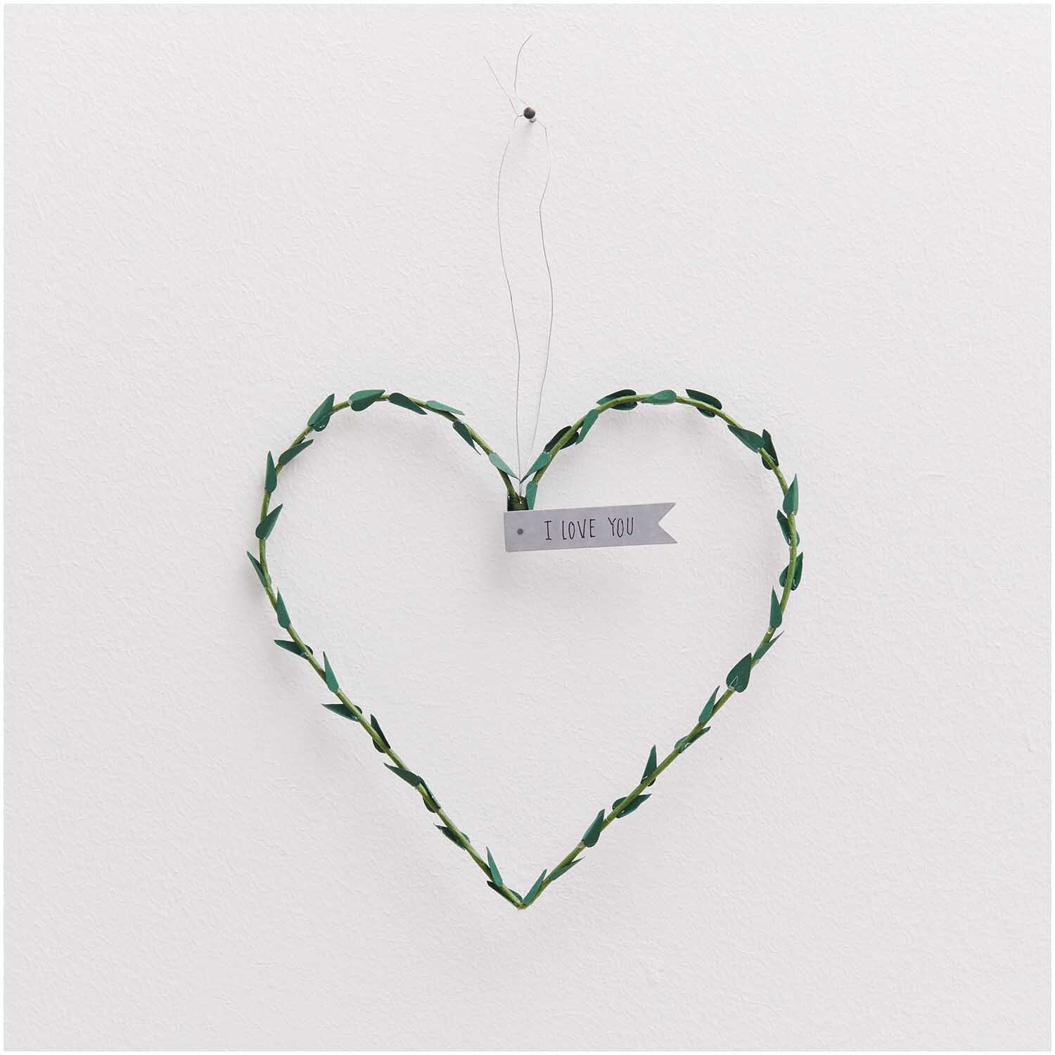 Papierdraht 1,8mm 1m 10 Stück: Herzförmiger grüner Draht mit "I Love You"-Schild, hängend an weißer Wand.