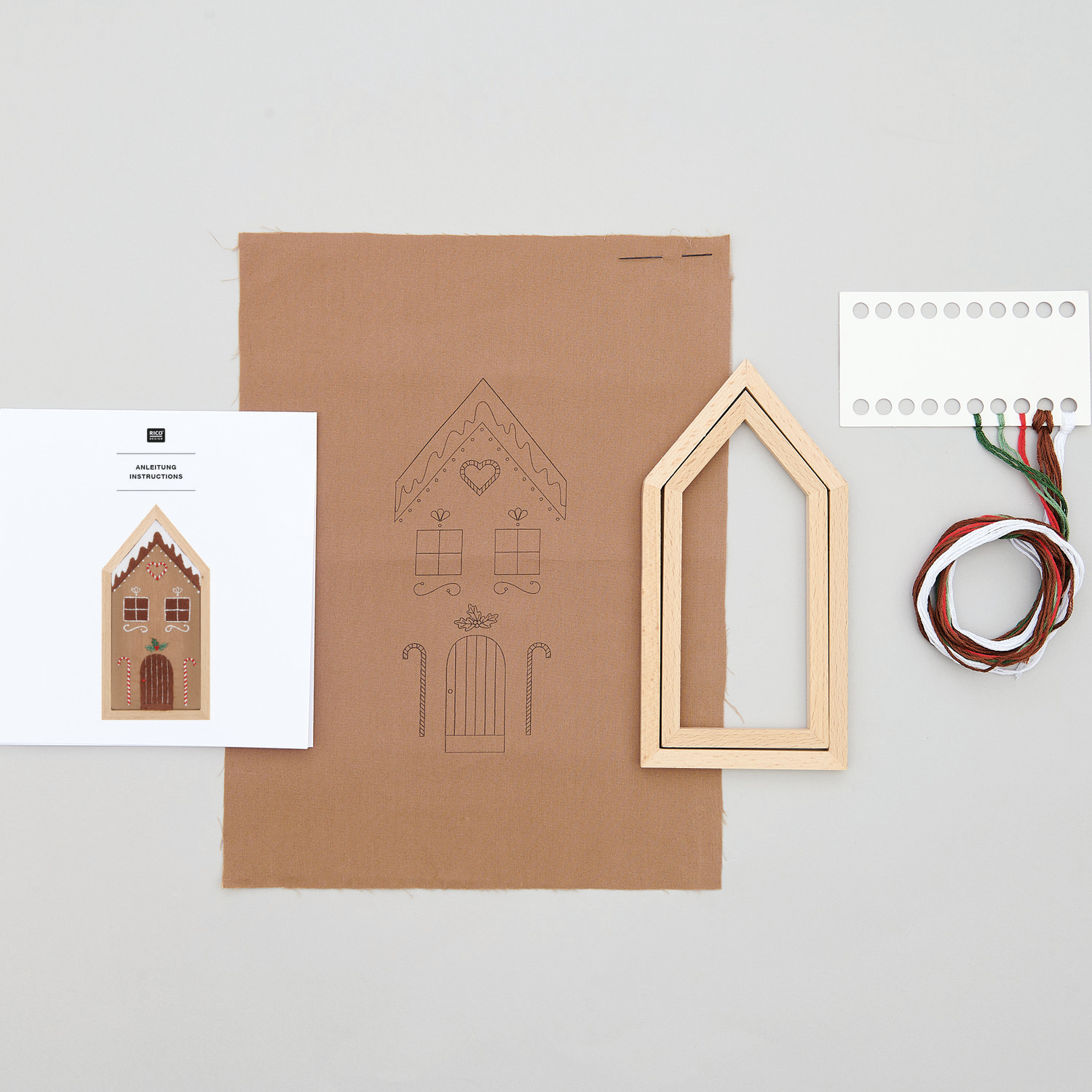 Stickpackung Lebkuchenhaus klein vorgezeichnet: Set mit Stoff, Holzrahmen und Garn von Rico Design, ideal für kreative Handarbeiten.