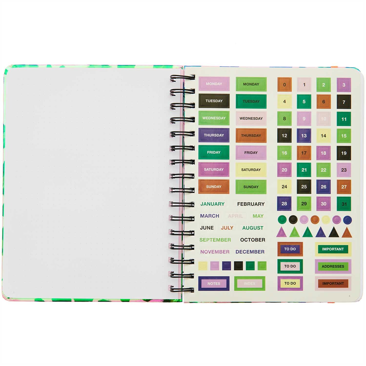 Paper Poetry Bullet Diary mit Spiralbindung, zeigt eine offene Seite mit bunten Aufklebern und leeren Seiten. Ideal für kreative Planung.