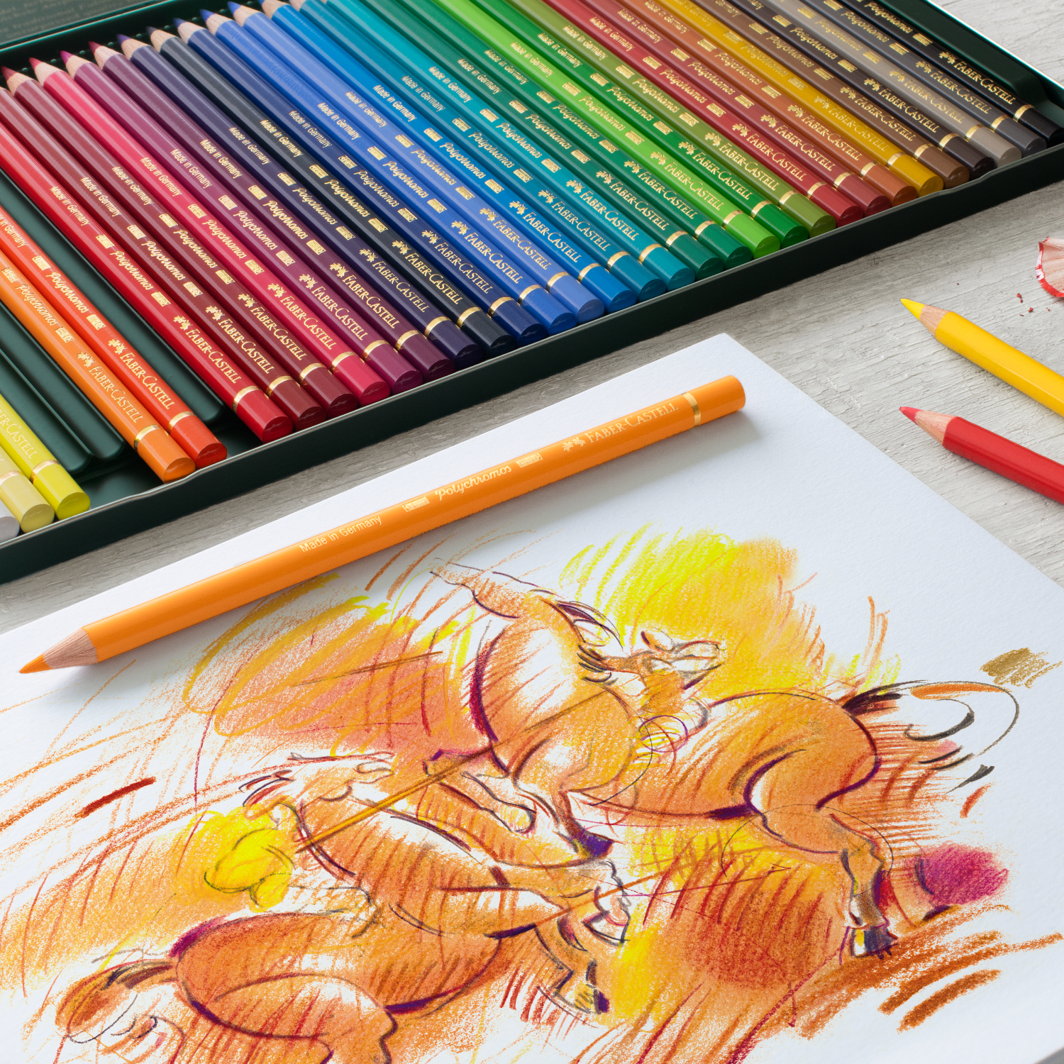 Polychromos Farbstifte Metalletui von Faber Castell, 36-teilig. Bunte Stifte und Zeichnung auf Tisch.