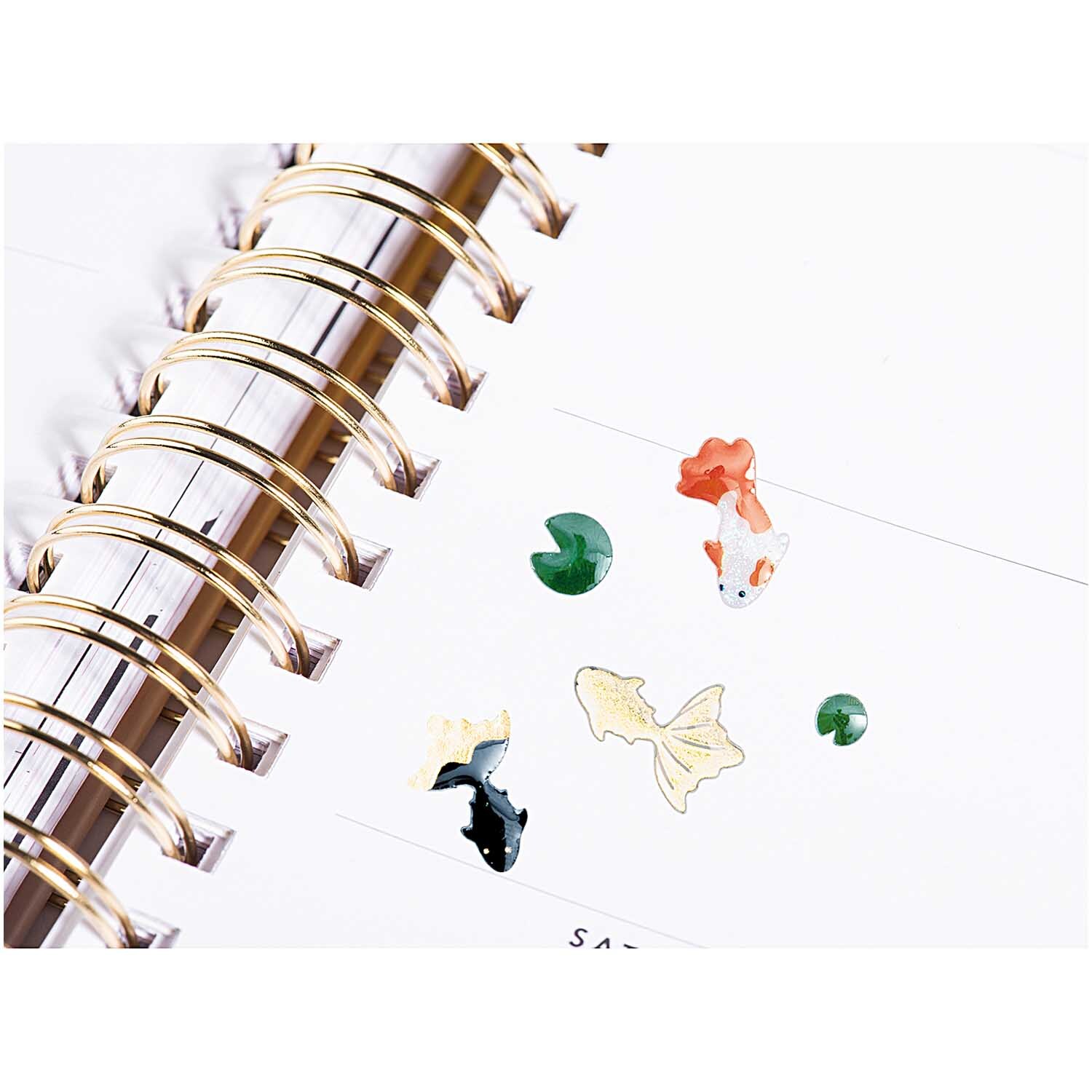 Paper Poetry Gelsticker Jardin Japonais zeigt bunte Kois und Lotusblätter auf einem Notizbuch. Ideal für kreative Dekorationen.