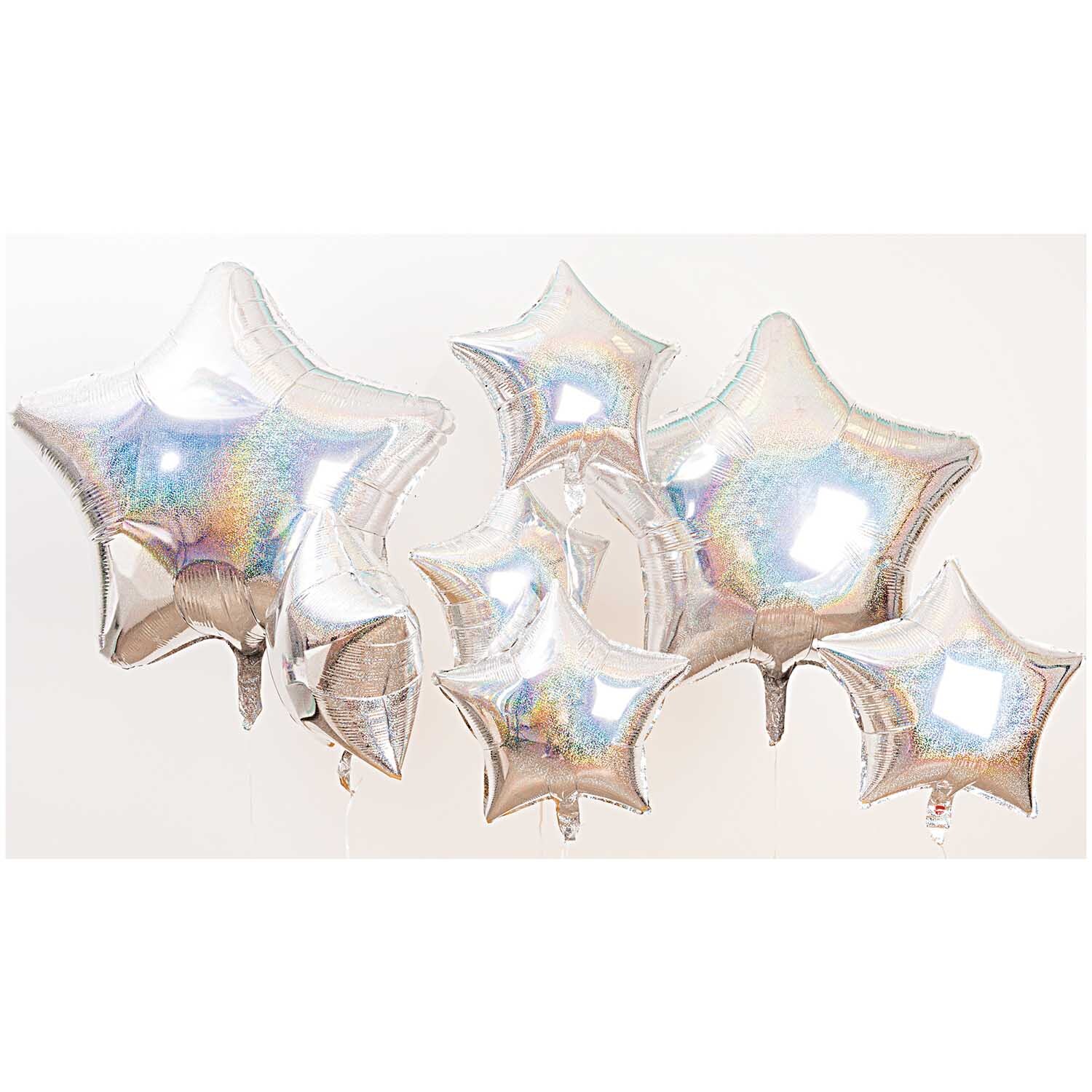Folienballon Stern silber-holographic groß 81cm von Rico Design. Mehrere schimmernde Sternballons in holografischem Silber. Ideal für festliche Dekorationen.