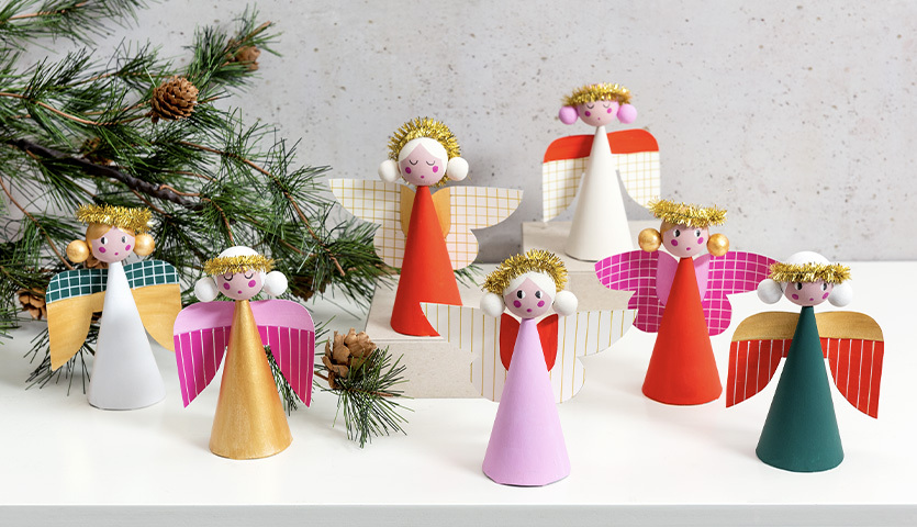 Bastelanleitung Engelfiguren: Bunte Engel aus Papier mit goldenen Details, ideal für festliche Dekorationen.