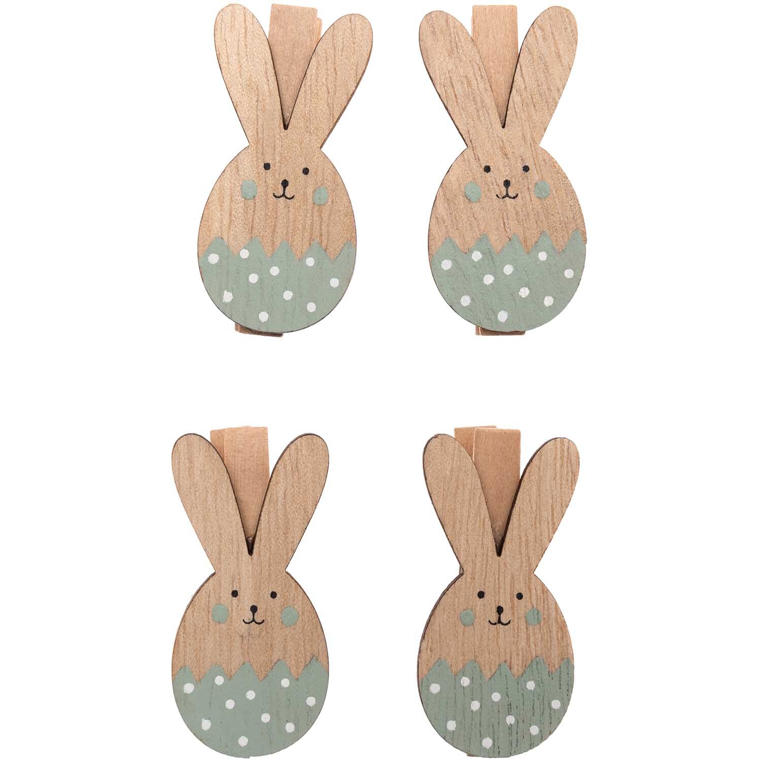 Dekoklammern Osterhase 4 Stück: Vier hölzerne Hasenklammern mit mintfarbenen Details von Rico Design. Ideal für Osterdekorationen.